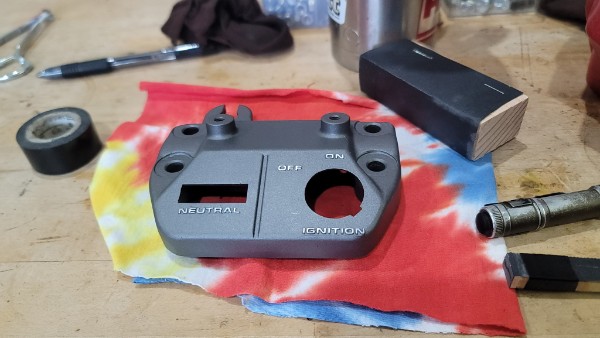 Honda ATC 70 ignition panel after restoration — clean matte gray finish, all markings visible, completely refinished