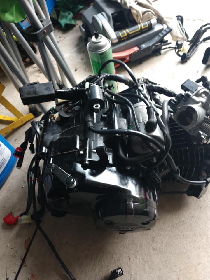 CBR300R 286cc liquid-cooled engine sitting on the garage floor, pulled from donor bike, ready for rebuild