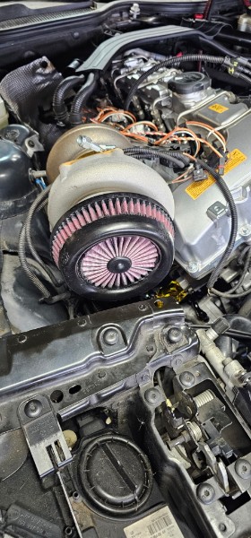 Steve's BMW Z4 engine bay with large single turbocharger, K&N filter, and intake plumbing mid-assembly