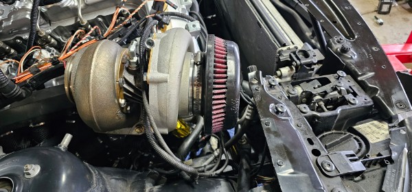 Large single turbocharger on Steve's BMW Z4 build with K&N filter, mid-assembly